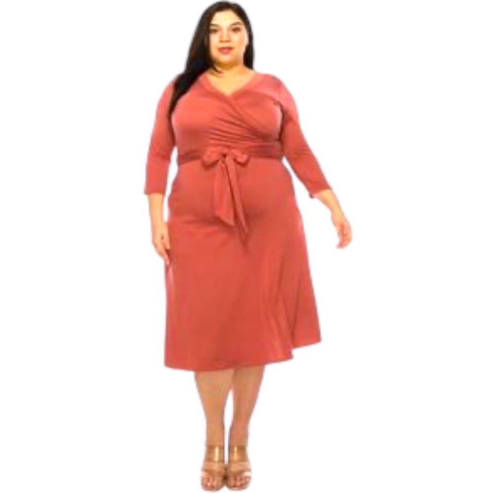 Plus size, solid faux wrap dress with deep V-neck and waist tie.